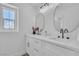Elegant bathroom boasts double sinks with oval mirrors, modern fixtures, and a bright window at 1551 Boundary Peak Way, Las Vegas, NV 89135