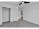 Spacious bedroom with carpet flooring, a closet, and a modern ceiling fan at 1551 Boundary Peak Way, Las Vegas, NV 89135
