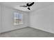 Minimalist bedroom with a window, carpeted floor, and a modern ceiling fan at 1551 Boundary Peak Way, Las Vegas, NV 89135