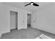 Minimalist bedroom with sliding closet doors, carpet flooring, and modern ceiling fan at 1551 Boundary Peak Way, Las Vegas, NV 89135