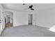 Clean bedroom with doorway to walk-in closet and bathroom, featuring neutral walls and modern ceiling fan at 1551 Boundary Peak Way, Las Vegas, NV 89135