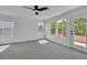 Bright bedroom features large windows and door to balcony, with modern ceiling fan and neutral decor at 1551 Boundary Peak Way, Las Vegas, NV 89135