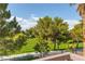 Scenic view of a lush green lawn with mature trees, creating a tranquil and inviting outdoor space at 1551 Boundary Peak Way, Las Vegas, NV 89135
