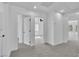 Bright hallway features neutral carpet, recessed lighting, white walls, and doorways leading to other rooms at 1551 Boundary Peak Way, Las Vegas, NV 89135