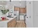 Modern kitchen features stainless steel appliances, wood cabinets, and a quartz countertop island at 1551 Boundary Peak Way, Las Vegas, NV 89135