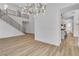 Spacious living area with modern staircase and open layout to the kitchen at 1551 Boundary Peak Way, Las Vegas, NV 89135