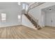 Bright and airy living room featuring a staircase, wood floors, and ample natural light at 1551 Boundary Peak Way, Las Vegas, NV 89135