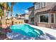 Stunning backyard pool with a rock waterfall feature, complemented by the home's elegant architecture at 1551 Boundary Peak Way, Las Vegas, NV 89135