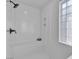 Modern shower stall with sleek fixtures, a built-in shelf, and a textured glass window for natural light at 1551 Boundary Peak Way, Las Vegas, NV 89135