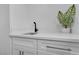 Stylish sink featuring a sleek black faucet, white countertops, and modern cabinetry, perfect for a functional space at 1551 Boundary Peak Way, Las Vegas, NV 89135