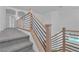 Staircase with wooden railing and black metal balusters leading to the upper level at 1551 Boundary Peak Way, Las Vegas, NV 89135