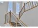 Upward shot of the staircase with wooden handrail and black modern metal balusters at 1551 Boundary Peak Way, Las Vegas, NV 89135