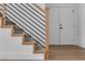 Modern staircase with wooden railing and metal balusters leading to the upper level at 1551 Boundary Peak Way, Las Vegas, NV 89135