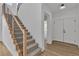 Elegant staircase featuring wood and iron railings, carpeted steps, and plenty of natural light at 1551 Boundary Peak Way, Las Vegas, NV 89135