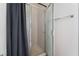 Bathroom featuring a glass door enclosed shower, gray shower curtain, and a towel rack at 1838 N Jones Blvd, Las Vegas, NV 89108