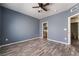 A blue bedroom with wood flooring and doors to the bathroom and closet at 1838 N Jones Blvd, Las Vegas, NV 89108