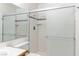 Bathroom shower features white tile, glass doors, and neutral accent tile at 2152 High Dunes Ln, Laughlin, NV 89029