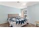 Cozy bedroom with slider to the deck, carpet, and light blue walls at 2152 High Dunes Ln, Laughlin, NV 89029