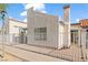 This home features a white stucco exterior, a terracotta tile roof, and a white fence at 2152 High Dunes Ln, Laughlin, NV 89029