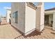 Home exterior featuring stucco walls, brick landscaping, and sliding glass door at 2152 High Dunes Ln, Laughlin, NV 89029