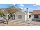Exterior view of a home featuring a white stucco wall, terracotta tile roof, and white fencing at 2152 High Dunes Ln, Laughlin, NV 89029
