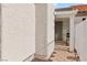 Home exterior showcasing stucco siding, brick landscaping, and backyard access at 2152 High Dunes Ln, Laughlin, NV 89029