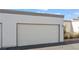 Attached garage with textured exterior, adjacent to desert landscaping at 2152 High Dunes Ln, Laughlin, NV 89029