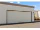 Attached garage with textured exterior, adjacent to desert landscaping at 2152 High Dunes Ln, Laughlin, NV 89029