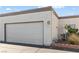 Attached garage with textured exterior, adjacent to desert landscaping at 2152 High Dunes Ln, Laughlin, NV 89029