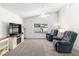 Spacious living room features plush carpeting, neutral-colored walls, and modern entertainment center with a fireplace at 2152 High Dunes Ln, Laughlin, NV 89029