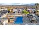 Community pool with hot tub and seating, surrounded by lush landscaping and great city views at 2152 High Dunes Ln, Laughlin, NV 89029