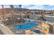 Community pool with seating and a spa, surrounded by lush landscaping with mountain views in the background at 2152 High Dunes Ln, Laughlin, NV 89029