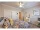 This is a cozy bedroom with a floral bedspread, dresser and closet at 2225 Blackburn Hills Ave, Henderson, NV 89044