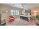 Inviting bedroom features neutral tones, plush carpeting, plantation shutters and a cozy armchair at 2225 Blackburn Hills Ave, Henderson, NV 89044