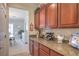 Elegant butler's pantry features granite counters, wine storage, and upper cabinets, with a glimpse into the dining room at 2225 Blackburn Hills Ave, Henderson, NV 89044