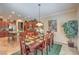 Dining room featuring wood table, decorative lighting, and open to the kitchen at 2225 Blackburn Hills Ave, Henderson, NV 89044