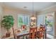 Dining room featuring a wood table, natural light, and access to the patio at 2225 Blackburn Hills Ave, Henderson, NV 89044