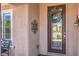 Close up of glass front door with wreath and sconce at 2225 Blackburn Hills Ave, Henderson, NV 89044