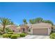 Attractive single-story home featuring a manicured front yard with desert landscaping and attached garage at 2225 Blackburn Hills Ave, Henderson, NV 89044