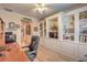 Inviting home office with custom built-ins, warm lighting, and hardwood floors at 2225 Blackburn Hills Ave, Henderson, NV 89044