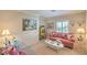 Comfortable living room furnished with a floral sofa, a coffee table, and decorative wall art creating a cozy atmosphere at 2225 Blackburn Hills Ave, Henderson, NV 89044