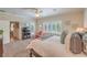 Bright main bedroom with shutters, ceiling fan, door to patio, and TV at 2225 Blackburn Hills Ave, Henderson, NV 89044