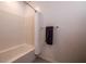 Functional bathroom featuring a combined tub and shower with a white curtain, complemented by neutral-toned walls at 226 Callen Falls Ave # 1311, Henderson, NV 89011