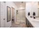 Modern bathroom featuring double sinks, a glass-enclosed shower, and neutral tile flooring for a clean aesthetic at 226 Callen Falls Ave # 1311, Henderson, NV 89011