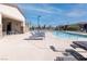 Community pool with plenty of space to relax, including tables, chairs, and lounge seating at 226 Callen Falls Ave # 1311, Henderson, NV 89011