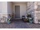 Inviting front porch featuring stone accents and comfortable seating with floral accents at 226 Callen Falls Ave # 1311, Henderson, NV 89011