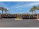 Secure gated entrance to the community, enhanced by lush palm trees and professional landscaping at 226 Callen Falls Ave # 1311, Henderson, NV 89011