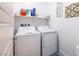 Bright laundry room featuring a full size washer and dryer and useful shelving at 226 Callen Falls Ave # 1311, Henderson, NV 89011