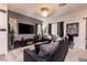 Modern living room featuring stylish decor, large TV, comfortable seating, and contemporary tile flooring at 226 Callen Falls Ave # 1311, Henderson, NV 89011