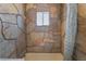 Stone shower with shower curtain and window at 2532 Arrowhead St, North Las Vegas, NV 89030
